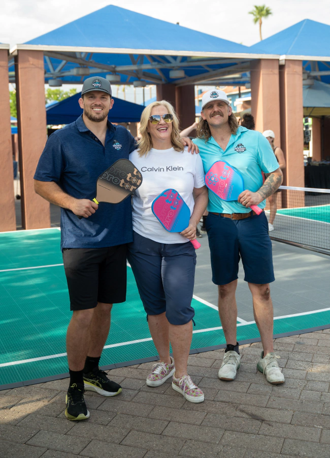 three person holding pickleball racket